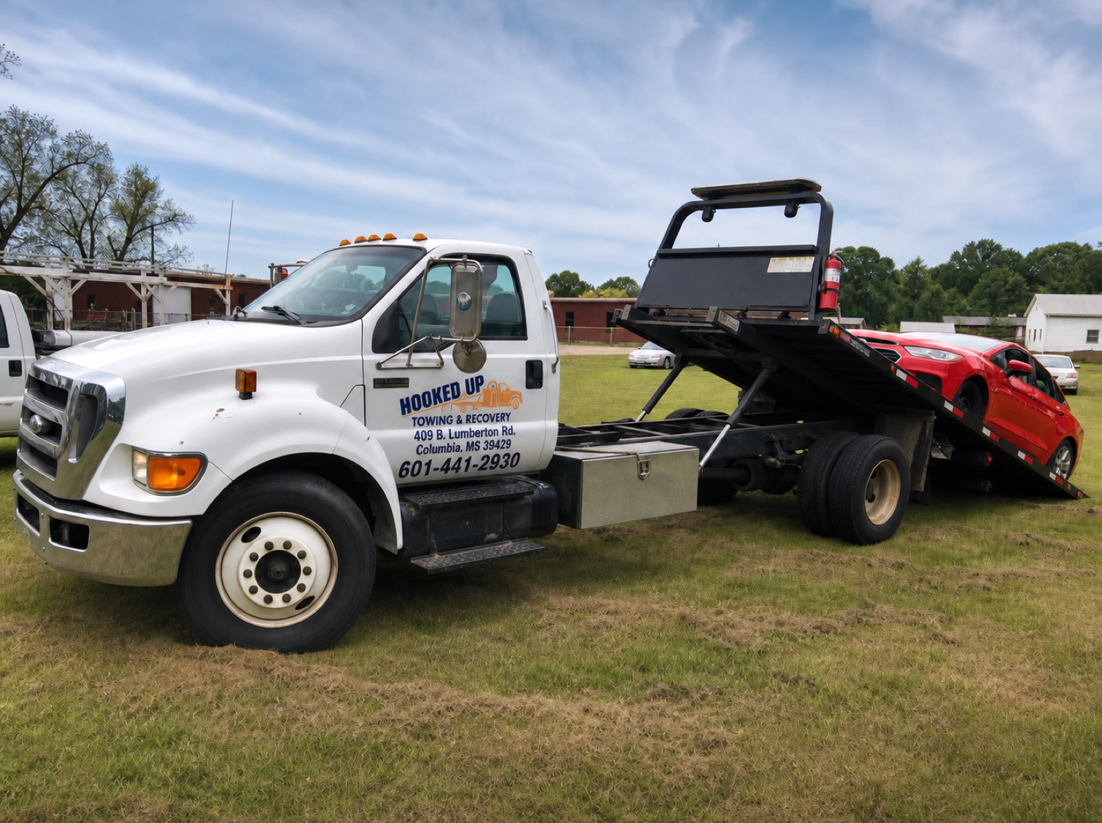 Hooked Up Towing F-650 flatbed loading a car